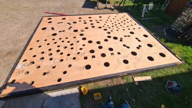 On the ground is a plywood template and frame of a show garden that can be dismantled, stored and reused.
